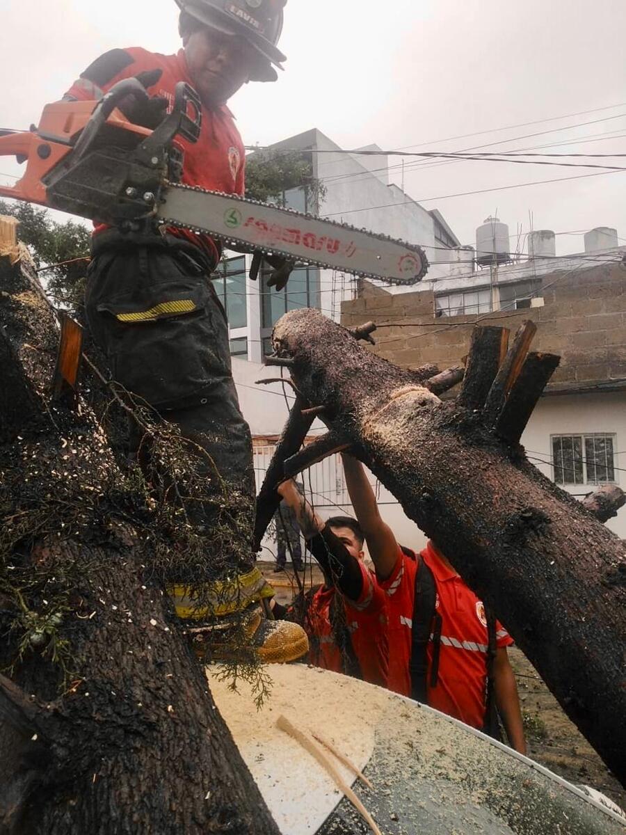 Personal de bomberos de Toluca atiende encharcamiento en el estacionamiento de las instalaciones de Servicios Educativos Integrados al Estado de México.