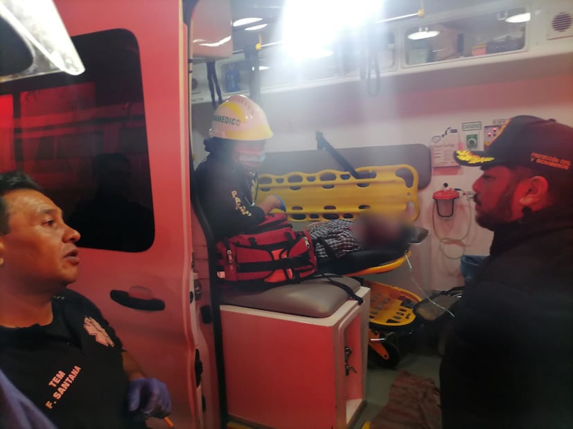 Paramédicos brindan primeros auxilios a un hombre de 47 años afectado por la intensa inhalación de humo durante la madrugada. Foto Especial